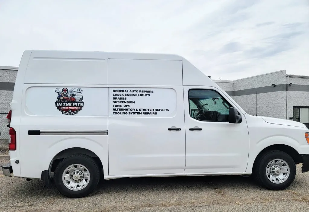 The white In The Pits service van with the logo and full service list lettered on the side